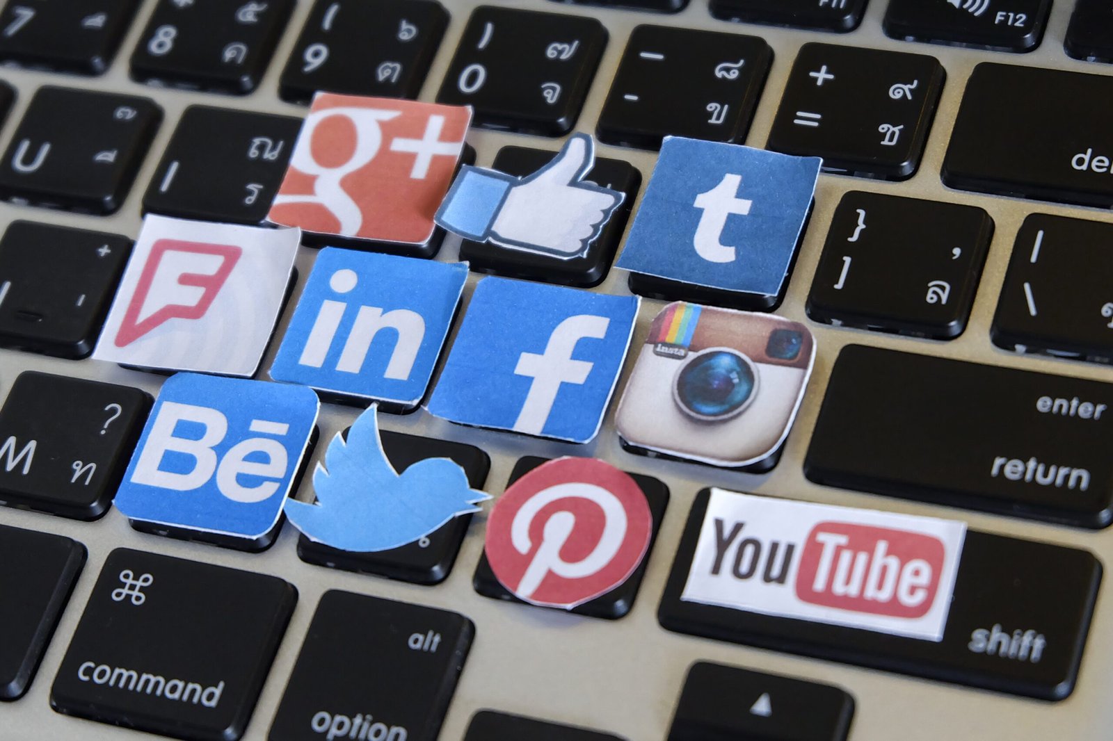 social media logos cutouts on keyboard