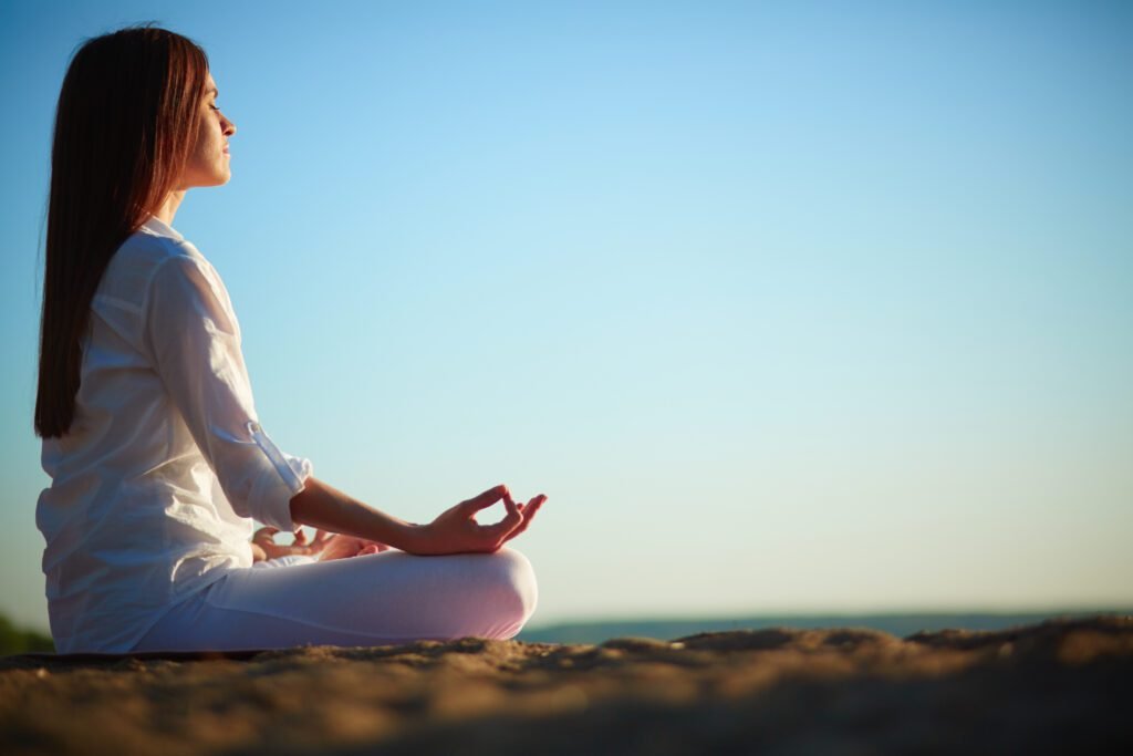 a person in yoga with on the sea shore