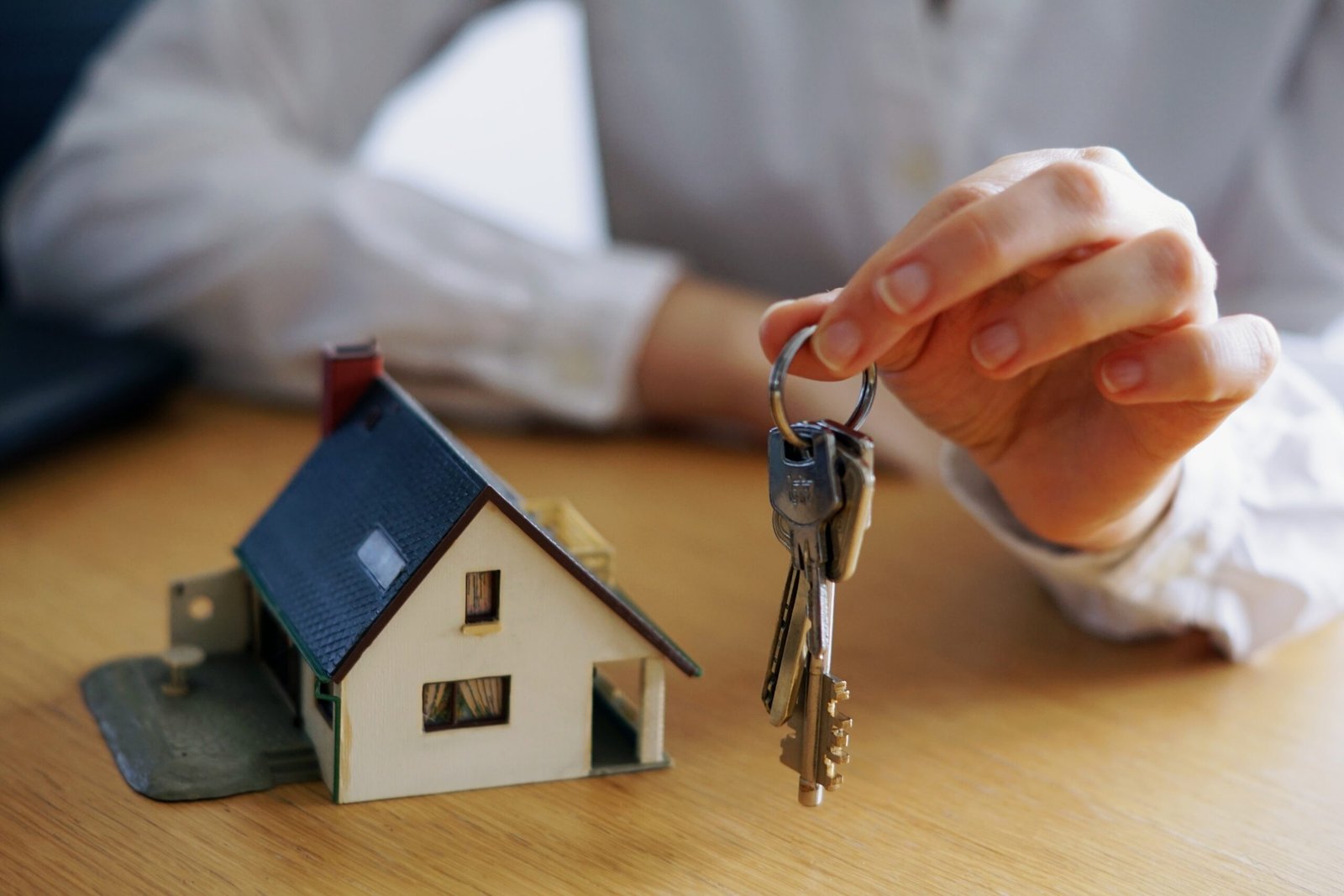 A closeup shot of a person thinking of buying or selling a house