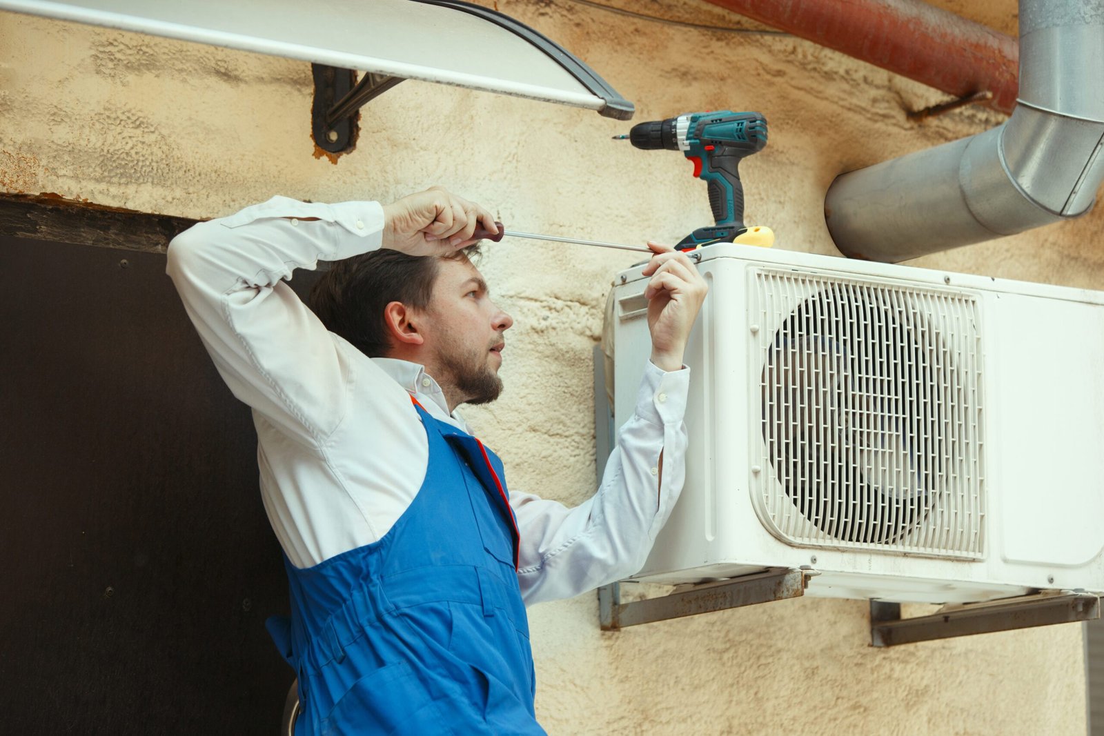 HVAC technician working to fix an air conditioner