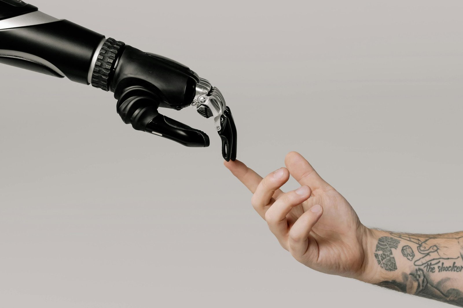 fauxmoi- a robot arm touching a human arn