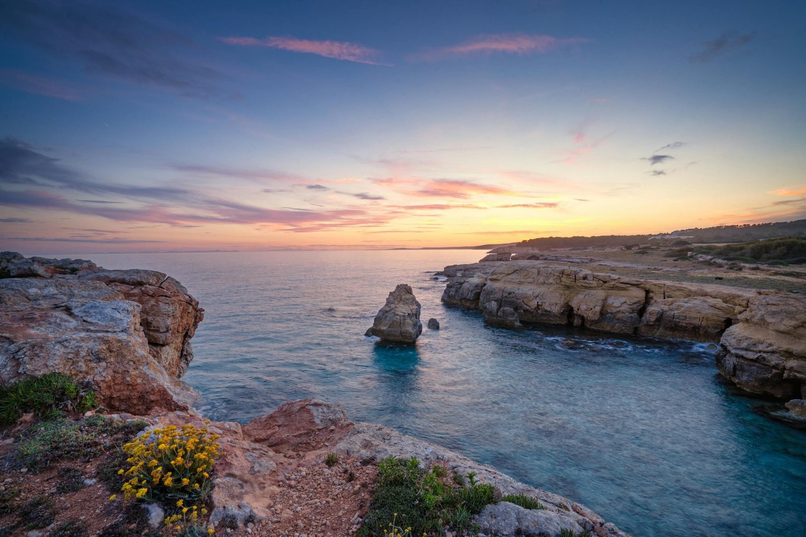 view of sea shore with cliffs on the side