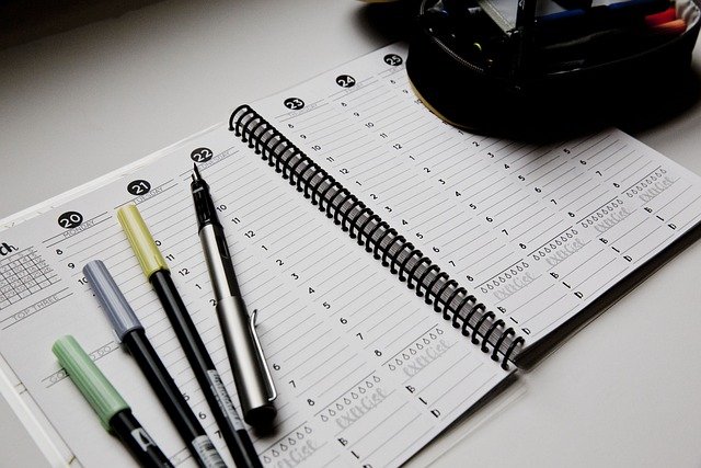 Planner with pens, highlighting a schedule for how many weeks in a school year.