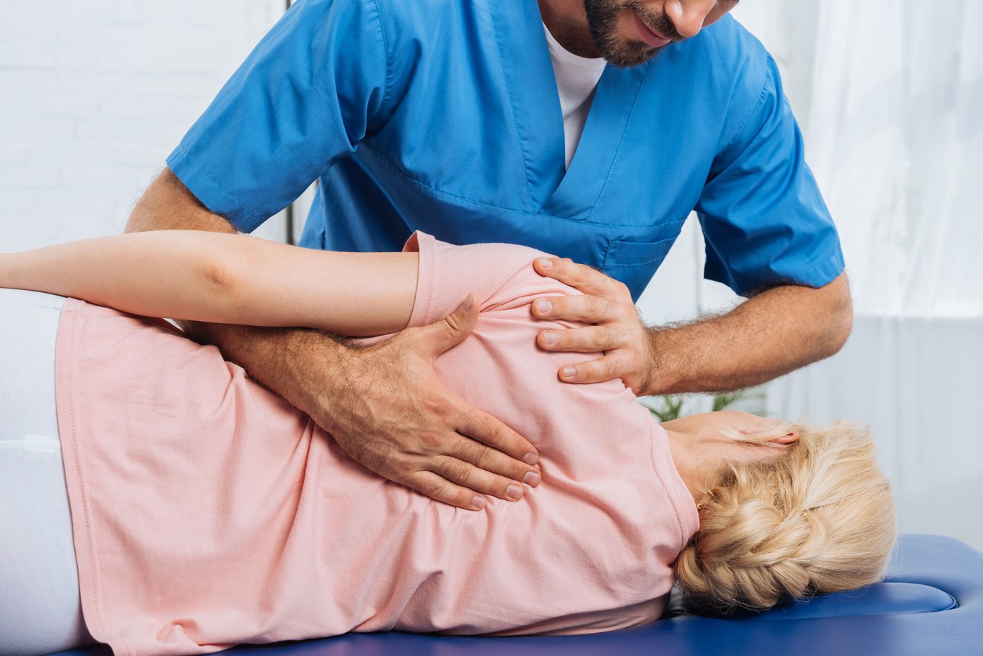 Chiropractor performing an adjustment on a patient, exploring the concept of What Toxins Are Released After Chiropractic Adjustment.