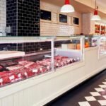 Interior of Rees Butcher Shop in Frostburg, Maryland, showcasing its fresh meat display, reflecting its rich history and local heritage. Map location nearby.